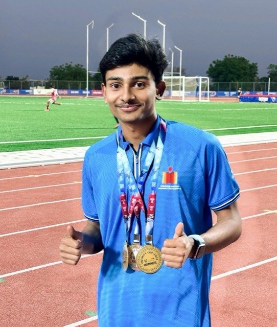 Chandan Mettu on the track wearing medals