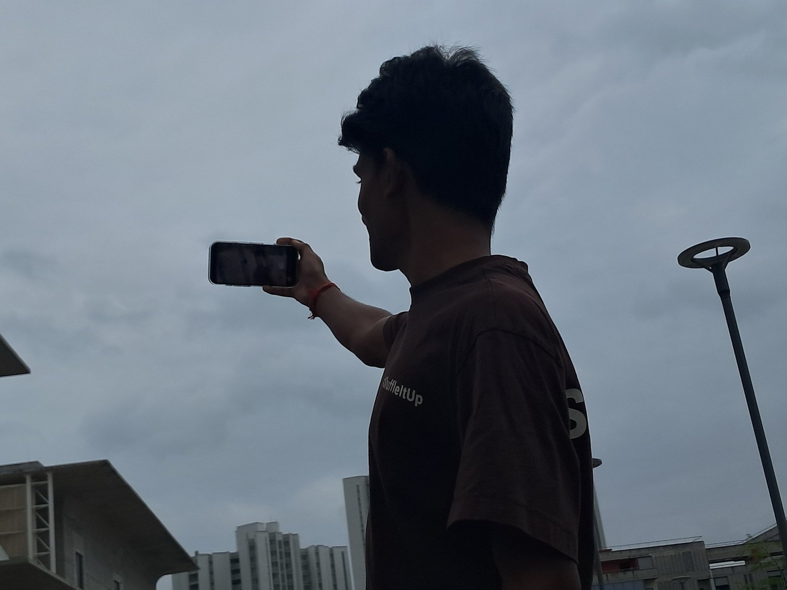 Chandan Mettu recording a video on his phone outdoors